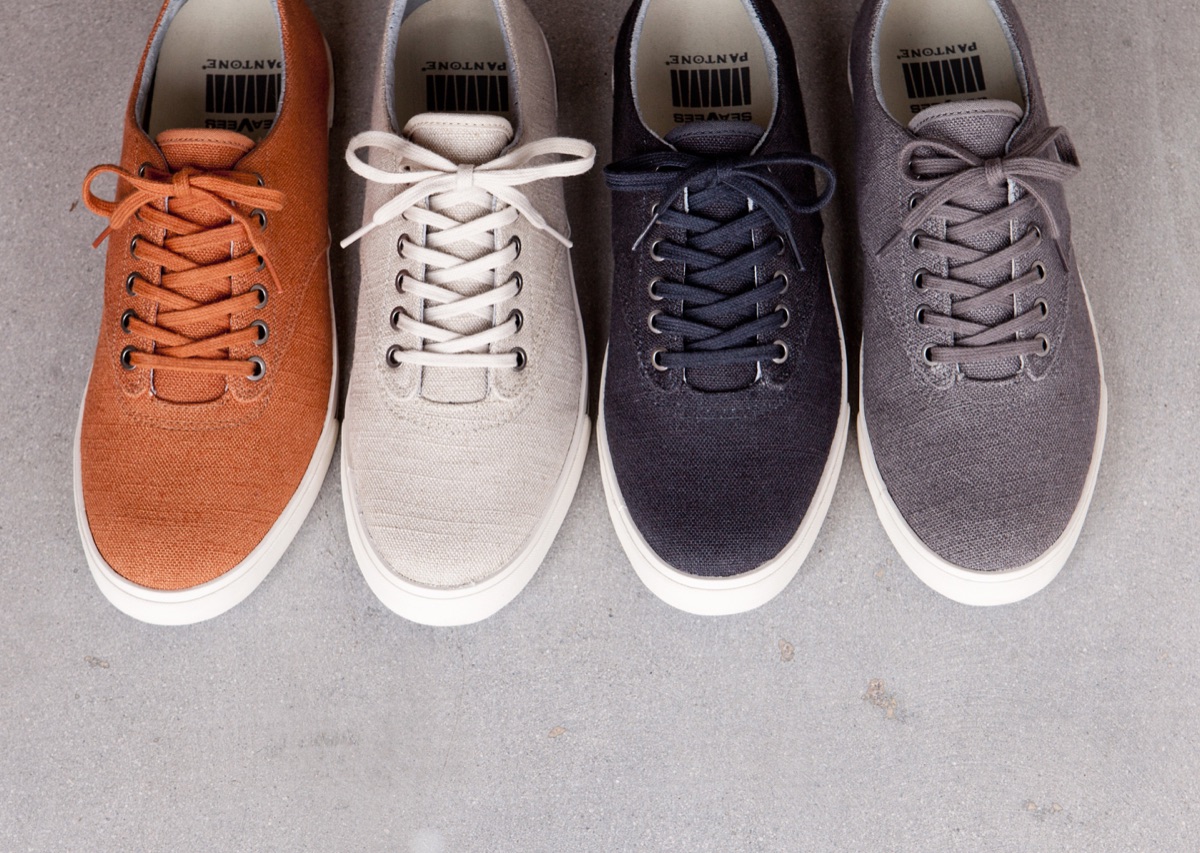 Four SeaVees × Pantone sneakers in rust, natural, navy and grey canvas, lined up on concrete