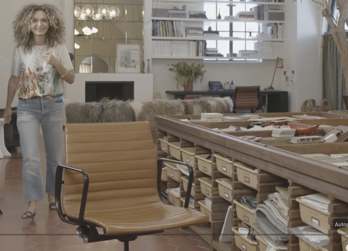 Still from the Autotype video: Pam Shamshiri walking through a design studio past a materials library
